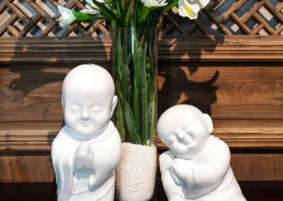 A pair of white porcelain smiley figurines