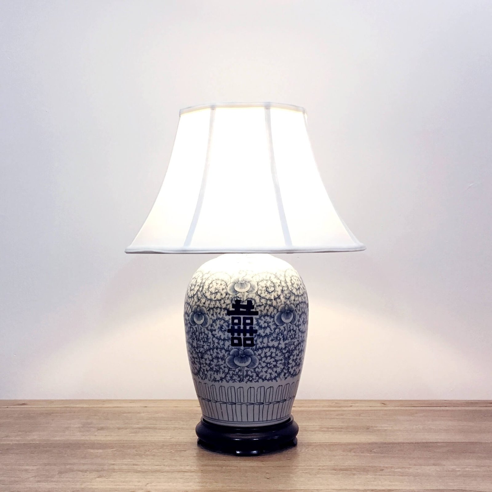 A round vase porcelain table lamp with blue & white double happiness pattern and a wooden base