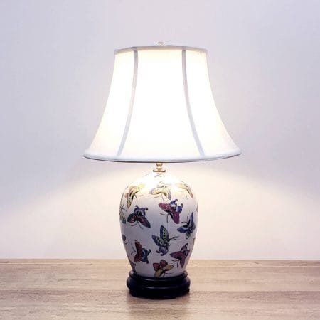 A porcelain table with colourful butterflies and a wooden base