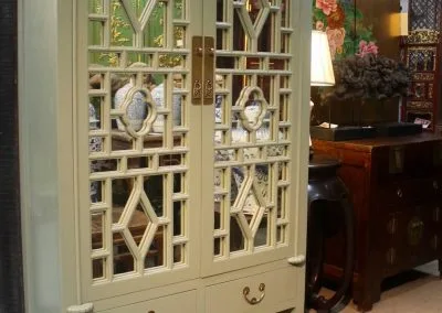 A mirrored lattice door cabinet in Sage Green, NEW