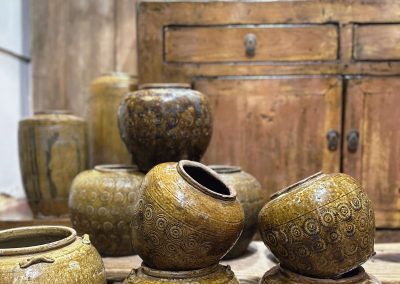 Chinese antique furniture and old ceramic pots in mustard and green