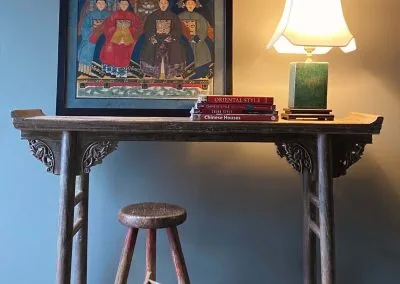 Antique table with everted flanges, ancestral portrait, chinese bench and stool