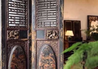 A pair of antique black and gold carved chinese doors