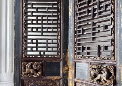 A pair of antique black and gold carved chinese doors