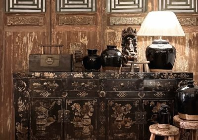 Chinese antique furniture, black painted Shanxi sideboard against a set of Chinese antique tall door panels