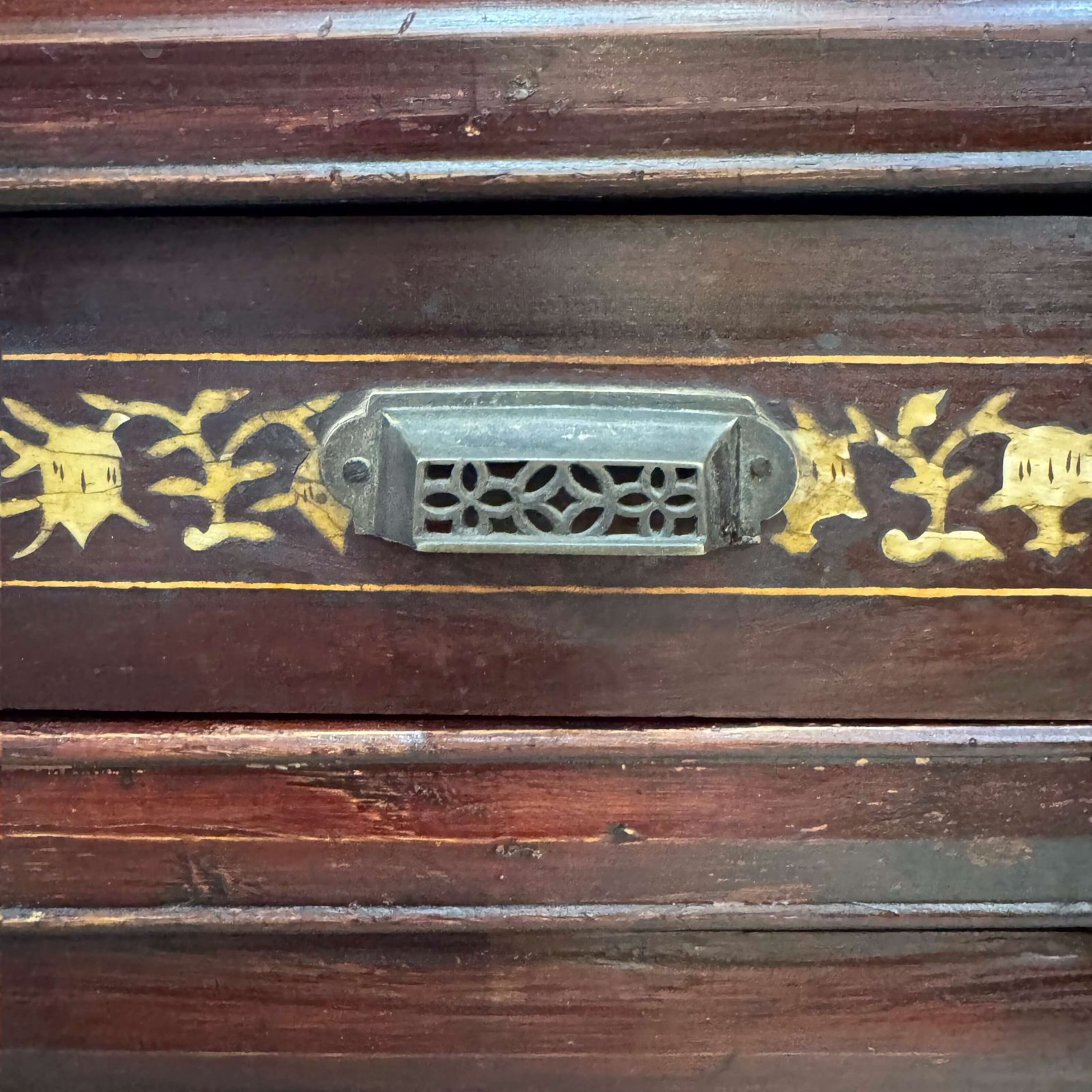 Close up on the bone inlaid designs on the drawer of a chinese antique cabinet