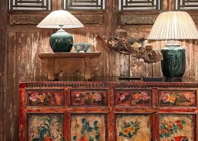 Chinese antique red painted sideboard against tall chinese antique doors