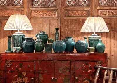 Chinese antique Gansu red painted sideboard with green vintage ceramics on top