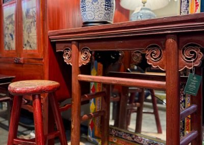 Chinese antique red wine table with clouds motifs, one of a pair