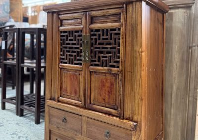 Small tapered cabinet with old lattice doors