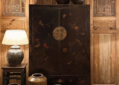 Chinese antique painted medium cabinet, standing against a set of tall chinese door panels