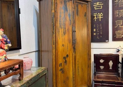 Chinese antique furniture cabinet in distressed mustard