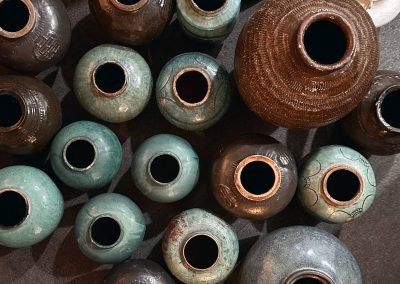 A top view of a variety of vintage ceramic Chinese pots
