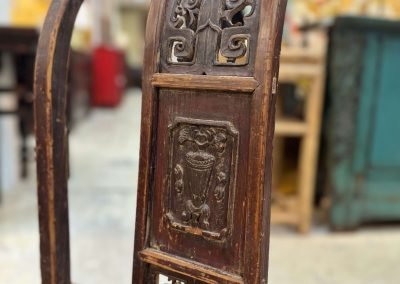 A close up shot of the carvings on the back of the chinese vintage sedan chair
