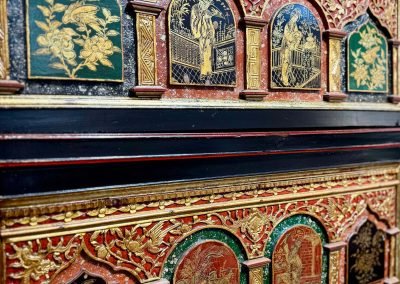 A close up shot of the carvings on the Chinese fujian vintage cabinet