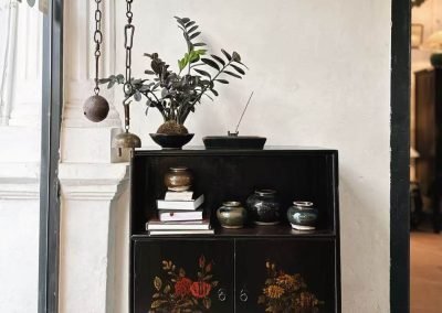 Chinese vintage small tea cabinet in black with floral paintings on the doors