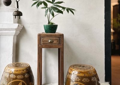 Chinese vintage furniture, a slim light brown rectangular tea table, flanked by a pair of vintage ceramic drum-shaped jars cum stools