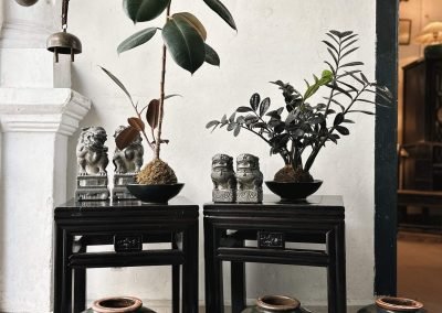 a pair of chinese vintage black square stools. The legs and frames have ribbed design, and the strut is a small square floral carving