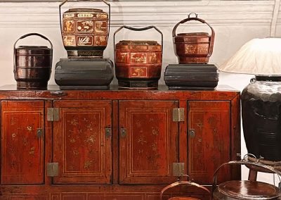Chinese vintage furniture, sideboard from Dongbei in red & gold. With assorted chinese vintage baskets from Wenzhou city