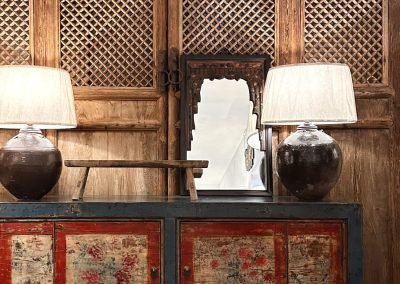 Chinese vintage furniture, Gansu painted sideboard in blue & red. Chinese antique tall door panels in the background