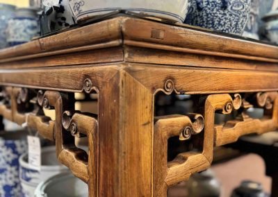 Corner of Chinese antique square table with carved sides