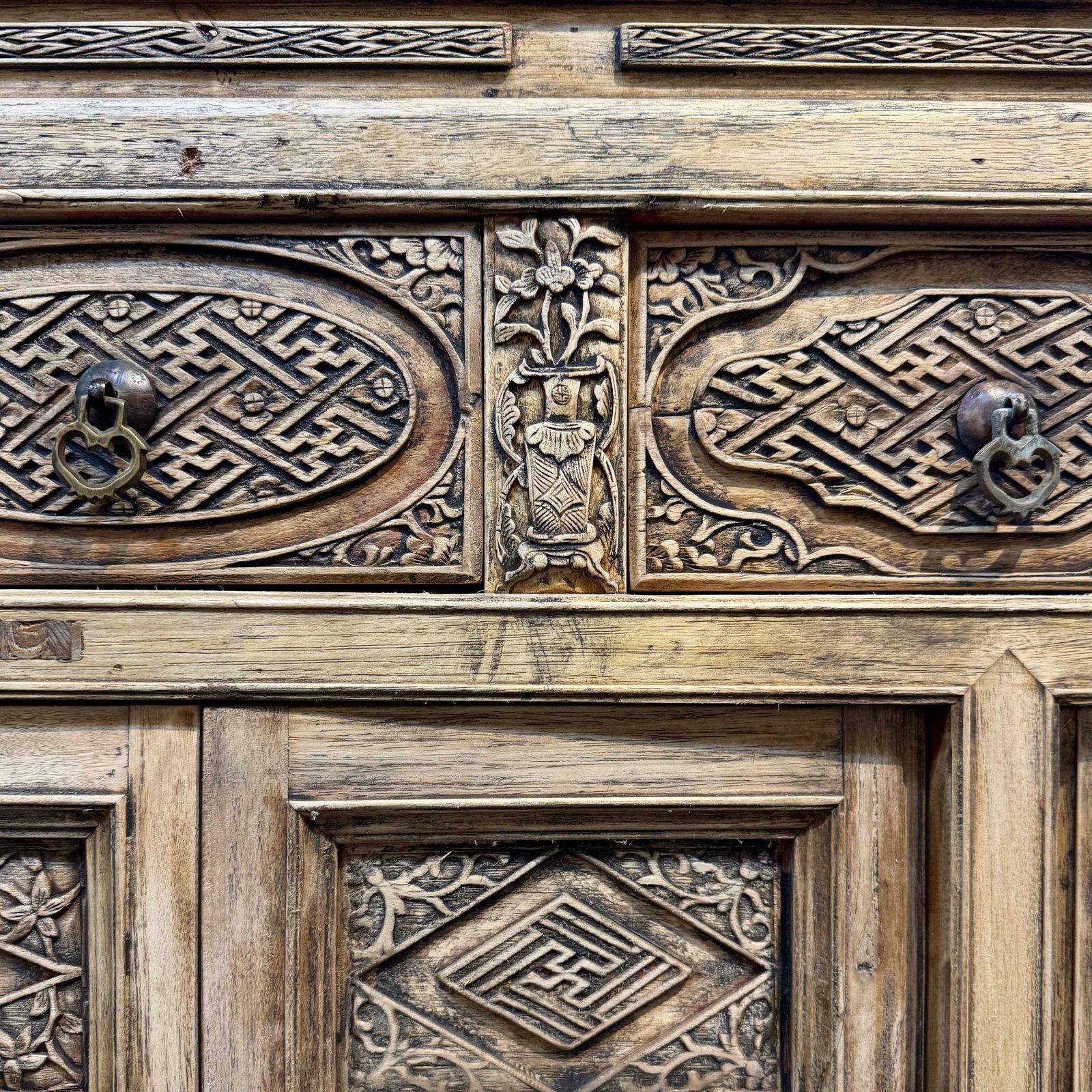 Close up of the beautiful relief carvings on the antique Chinese sideboard