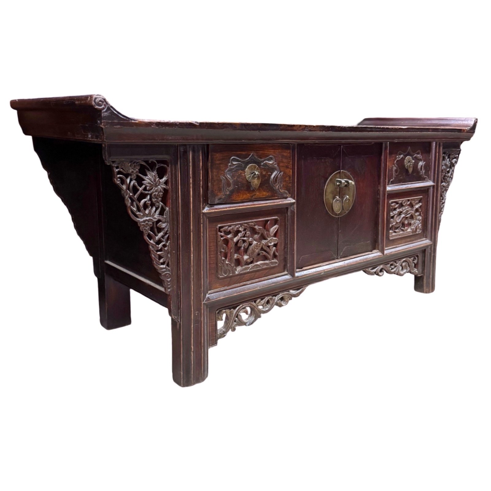 Angled view of Antique Chinese low small sideboard with everted flanges and carved crane and deer panels