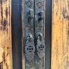 Close up of original chinese brass cabinet door handles with coin and floral motifs